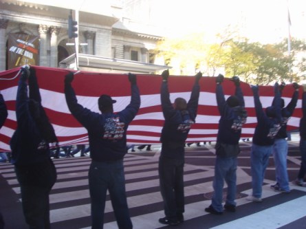 20071111-veterans-day-parade-15-wtc-ground-zero-flag-being-waved.jpg